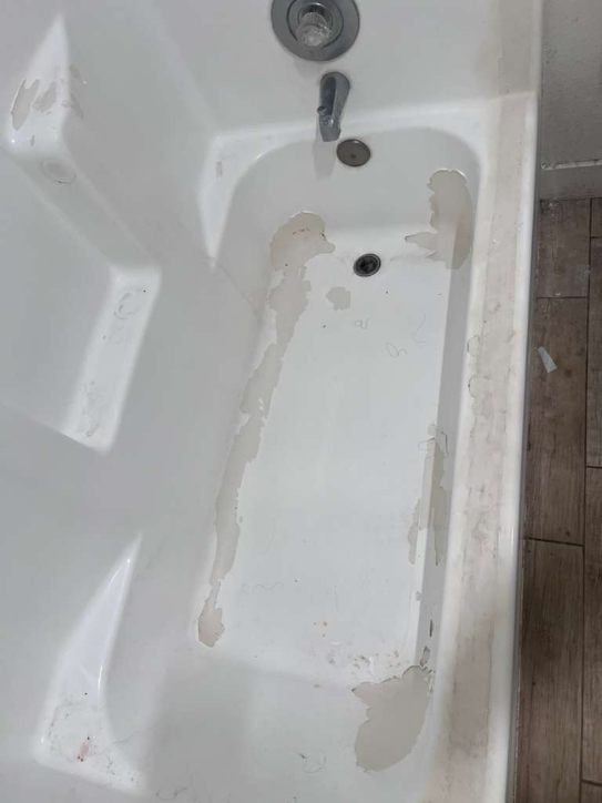 Old, chipped bathtub surface ready for refinishing or repair.