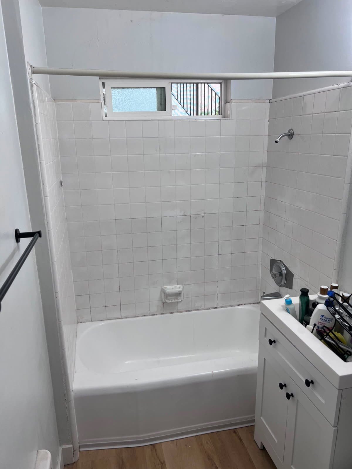 Refinished bathtub with clean white tiles and modern fixtures in La Jolla bathroom.
