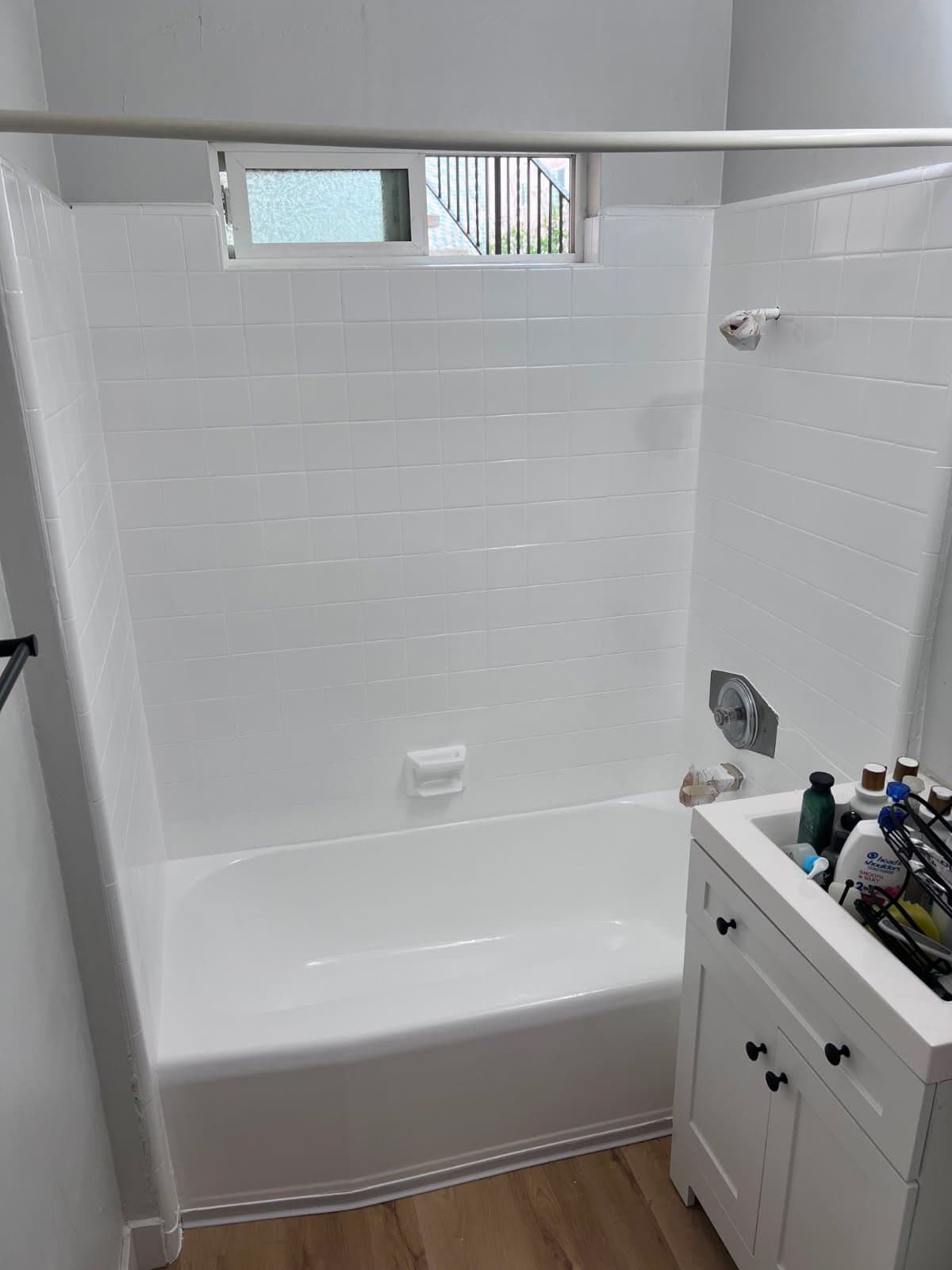 Refinished white bathtub with clean tiles in La Jolla bathroom.